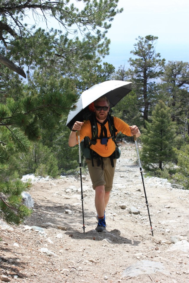 Junaid hiding from the sun on the climb up to the Blanca group.