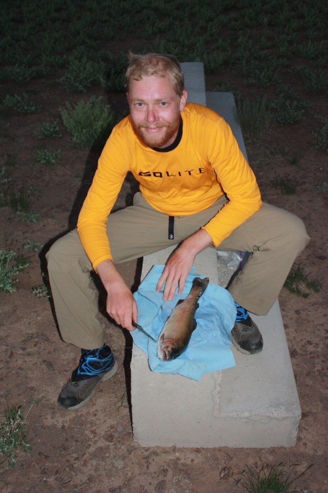 Preparing the trout that a friendly farmer gave us late in the day on the San Luis crossing.