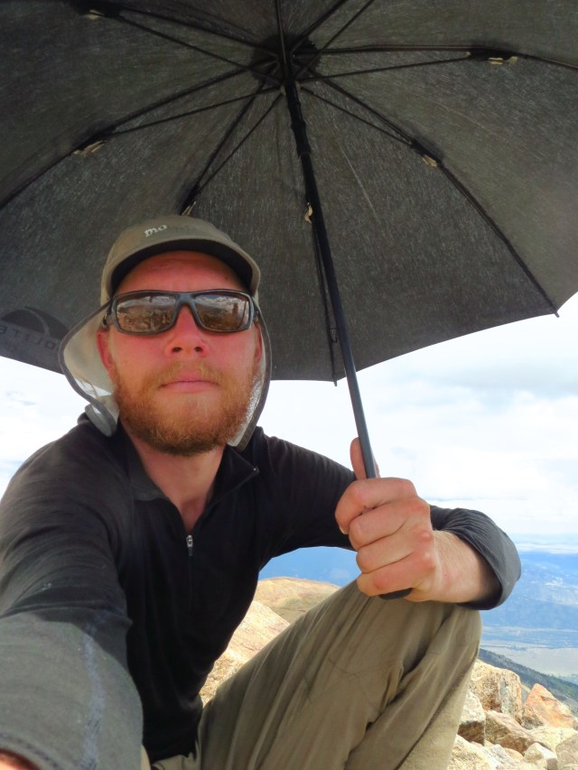 Junaid hides from the sun on the summit of Columbia.